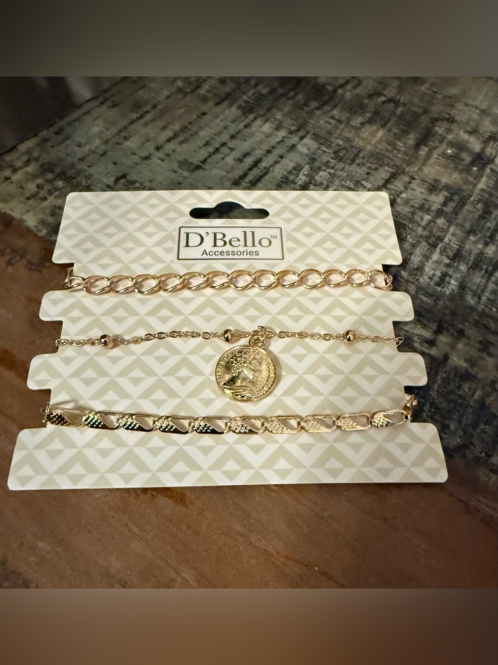 Set of 3 D’Bello packaged gold toned bracelets.